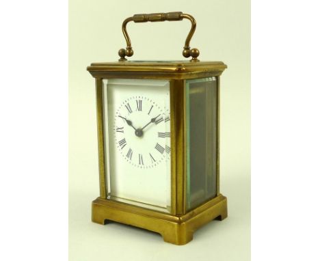 A French late 19th/ early 20th century brass carriage clock, with bevelled plates, white enamel dial with black Roman numeral
