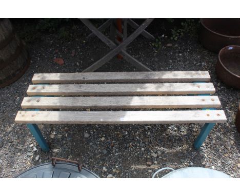 A wooden slatted bench on metal legs 