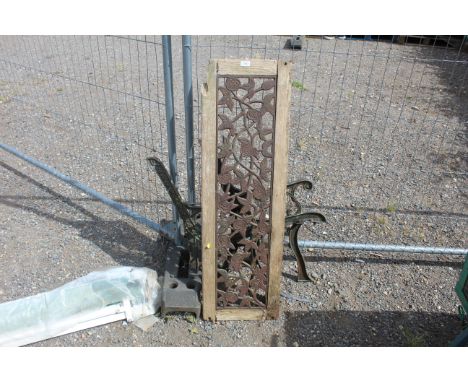 A garden bench with cast iron bench ends and floral motif back rest AF