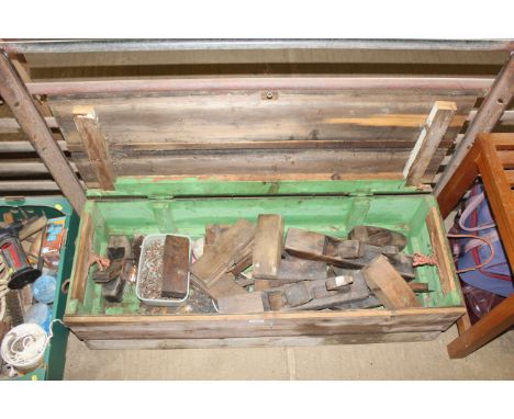 A wooden tool chest and contents of tools to include wooden smoothing planes, jack planes, a quantity of screws etc.