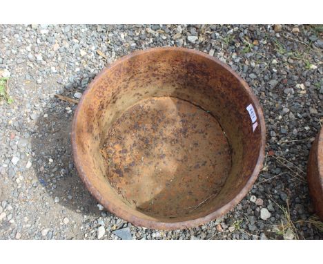 A circular cast iron planter, approx. 16" dia.