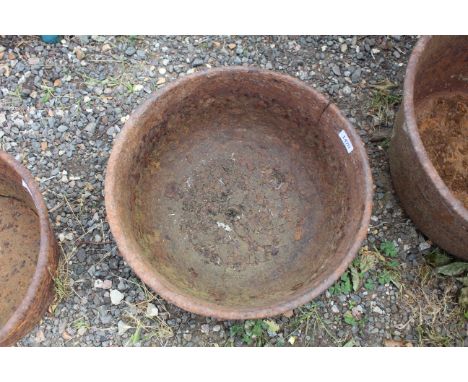 A circular cast iron planter, approx. 17" dia.