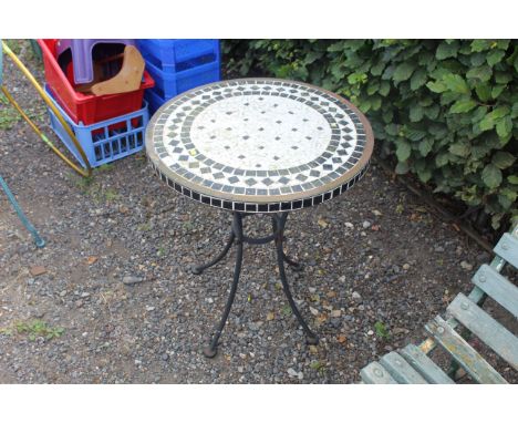 A circular tile topped garden table 