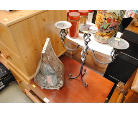 A wrought metal three light candelabra and a candle lantern
