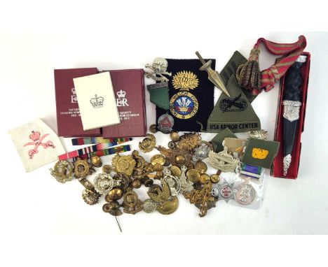 Assorted British Army cap badges, cloth badges and buttons, a reproduction Scottish dirk in box, four Diamond Jubilee medal b