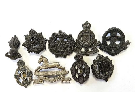 Nine British Second World War economy issue bakelite badges, comprising Royal Army Service Corps, West Yorkshire, Royal Artil