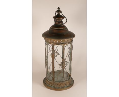Ornate metal and glass round lantern, with hinged door and carrying handle, h.57 x d.25cm.