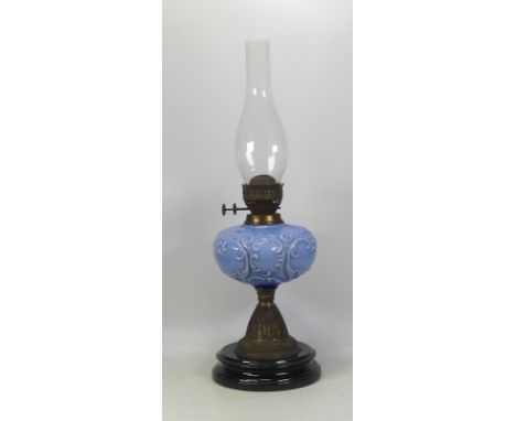 Victorian Oil Lamp. Earthenware base, brass fittings, blue milk glass reservoir and chimney present. Height: 57cm