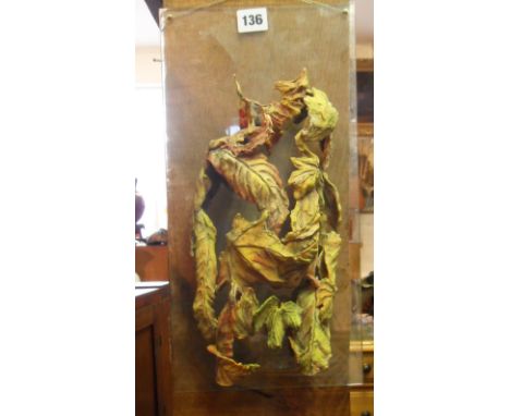 Contemporary ceramic "leaf" sculpture of a stylised male torso mounted on perspex  