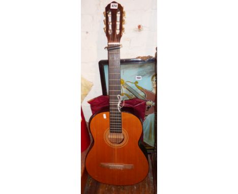 Spanish acoustic guitar with tuning tools, guitar book & strap