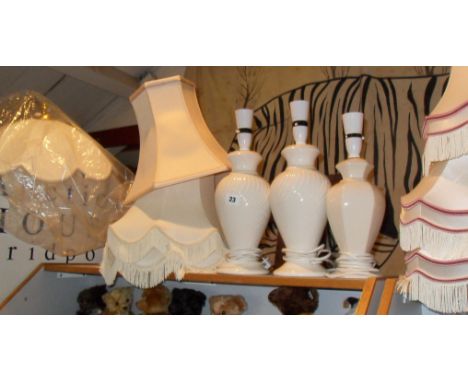 Three table lamps and assorted light shades