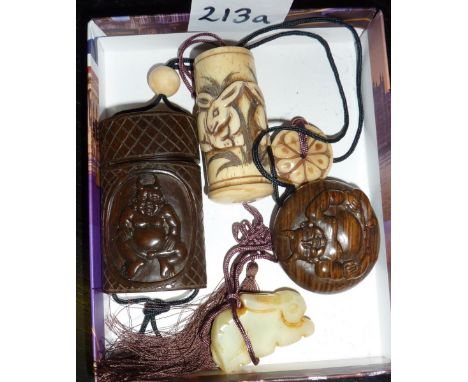 A Japanese hardwood lnro and netsuke depicting demons and a Japanese bone inro carved with rabbits, attached to a carved jade