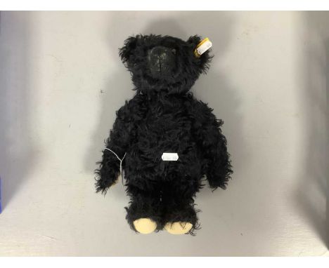 A Modern Black Bear by 'Steiff' with Growler, 31cm high, ear button in tact.