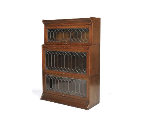 An early 20th century Globe Wernike glazed three tier bookcase. With leaded astragal glazed hinged doors, on plinth base, L87