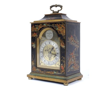 An early 20th century chinoiserie mantel clock. The brass face engraved with baskets of flowers, centred with a silvered plaq