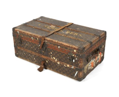 An early 20th century Louis Vuitton travelling trunk. With leather straps, studded and tooled leather and wooden banding, on 