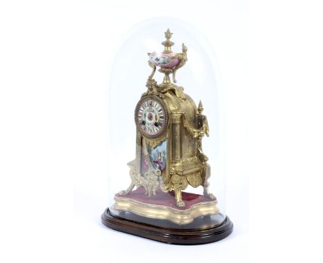 A gilt-metal Sevres-style porcelain mounted mantel clock, circa 1900. Mounted with a ceramic urn decorated with a bird and to