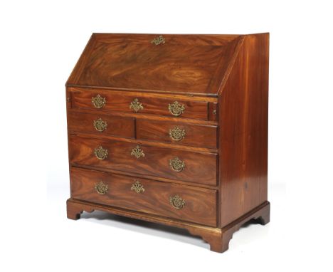 A Georgian mahogany fall front bureau. The interior fitted with a cupboard, drawers and pigeon holes above a long slim drawer