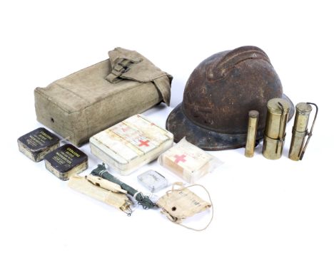 A British Army post war web pouch with contents, WWI French helmet and other collectables. The pouch containing First Aid kit