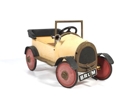A vintage Brum ride-on pedal car. Painted in pale orange, with horn, pedals and crank, the number plate inscribed BRUM, 89cm 
