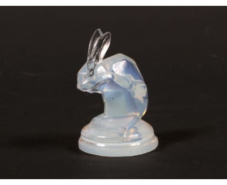 A Lalique opalescent glass model of a rabbit. With faceted face and body, on shaped circular base, etched R. Lalique/France m