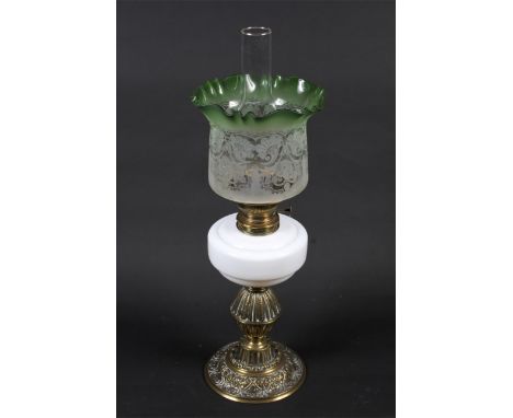 A Victorian brass mounted oil lamp. With green floral etched frilled shade, chimney and opaque white reservoir, the burner st