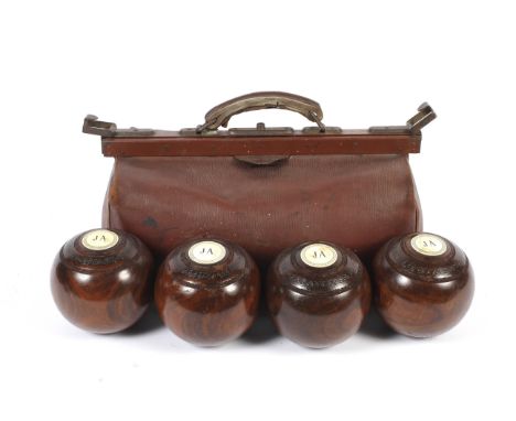 A vintage 20th century Gladstone-style bag and a set of four lignum vitae bowls. Each inset with plaque initialled J.A. in bl
