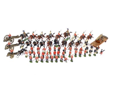 A vintage collection of assorted Britain lead toy soldiers. Including 'Dragoon Guards', horse mounted Lancers and four canons