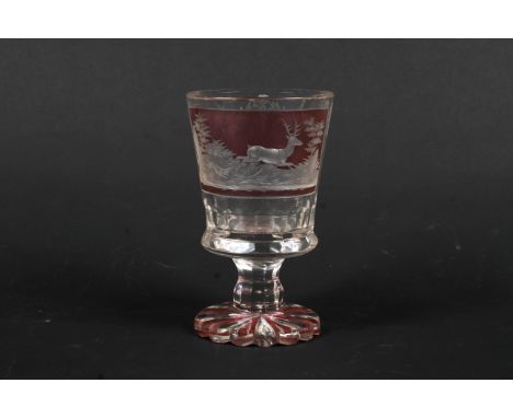 A 19th century Bohemian flashed and engraved hunting goblet. The tapering bucket shaped bowl engraved with a stag pursued by 