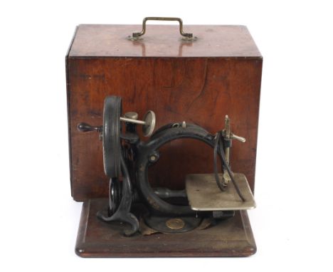 A vintage hand crank small table top chain stitch sewing machine. By Willcox &amp; Gibbs, cast iron with gilt grape and vine 