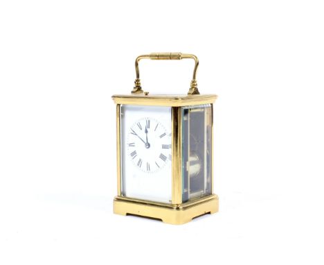 Late 19th century French brass cased carriage clock. The white dial with Roman numerals, glazed panels to each side, carry ha