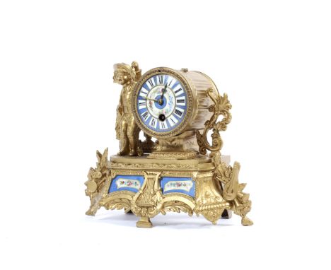 A gilt-metal and porcelain mounted mantel clock, circa 1900. Mounted with a young boy holding a fish, reeded barrel-shaped cl