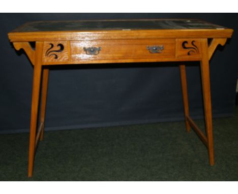 An Arts and Crafts oak single-drawer writing desk with gilt and tooled leather insert and flared supports CONDITION REPORT; L