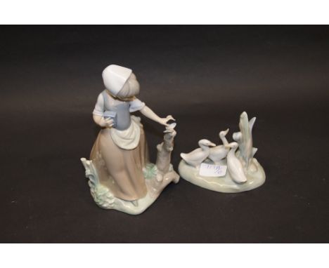 Two Nao figures; one of a young girl, the other of Geese at play