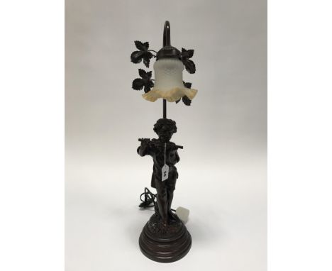 A figural lamp of a boy playing a flute
