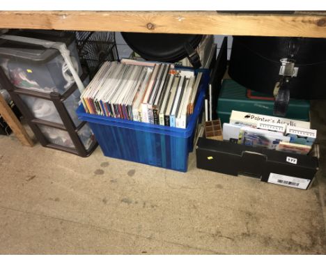 Shelf of sewing books and materials, a brass bird cage, black circular Antler luggage case and a black circular Charles of th