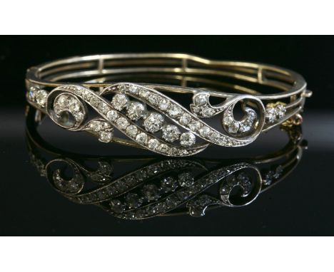 A Victorian diamond set hinged bangle,with a centrepiece of five graduated old European cut diamonds, set diagonally in a row