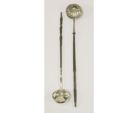 A George II silver punch ladle,unmarked,with twisted whalebone handle, the bowl inset with a coin, surrounded by embossed fol