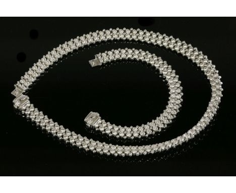 An Italian gold necklace and bracelet suite,with feature clasps set with cabochon sapphires.  The necklace composed of a cent