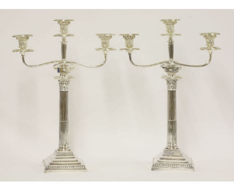 A matched pair of Victorian silver Corinthian column three-light candelabra,the candlesticks by Hawksworth, Eyre & Co. Ltd., 