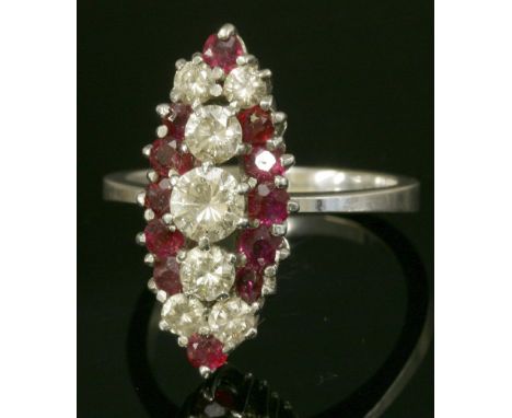 A white gold, ruby and diamond marquise-shaped cluster ring,with three central graduated brilliant cut diamonds, surrounded b