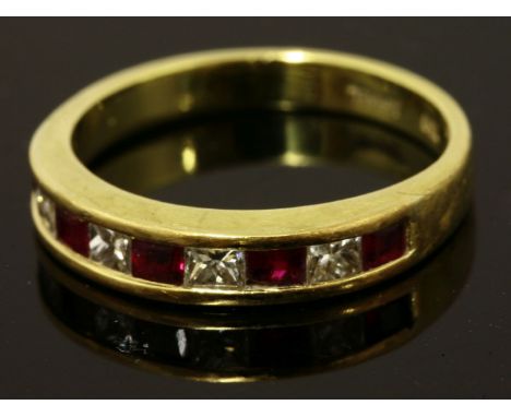 A ruby and diamond half eternity ring,by Tiffany & Co. with a row of princess cut diamonds and calibré-cut rubies, channel se