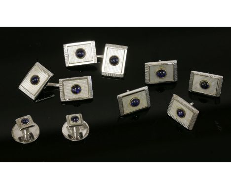 A cased 9ct white gold, sapphire and mother-of-pearl dress stud set, by Cropp & Farr,retailed by J W Benson.  Each rectangula