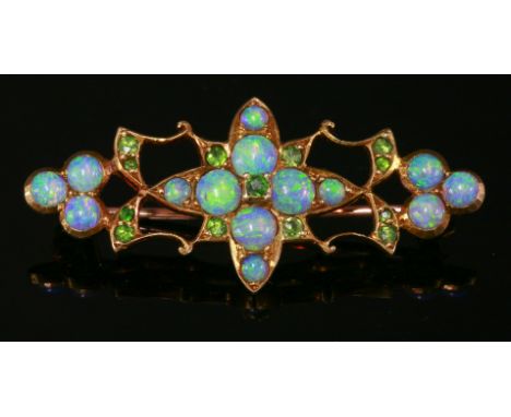 A cased Edwardian opal and demantoid garnet brooch,with a central quatrefoil cluster of circular cabochon opals with demantoi