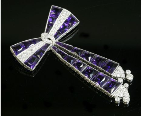 An Art Deco amethyst and diamond geometric style bow brooch,with pendant ribbons.  A bow tie style top with a central line of