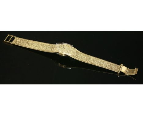 A ladies' 9ct gold Omega Genève mechanical bracelet watch, c.1970,a circular, champagne, raised baton dial with black hands, 