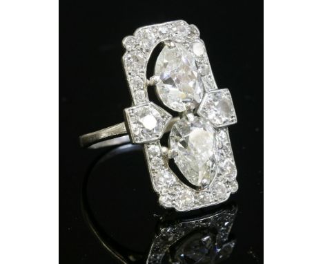 An Art Deco diamond set plaque ring, c.1925,of rectangular portrait form.  Two old pear cut diamonds, claw set, end to end, w
