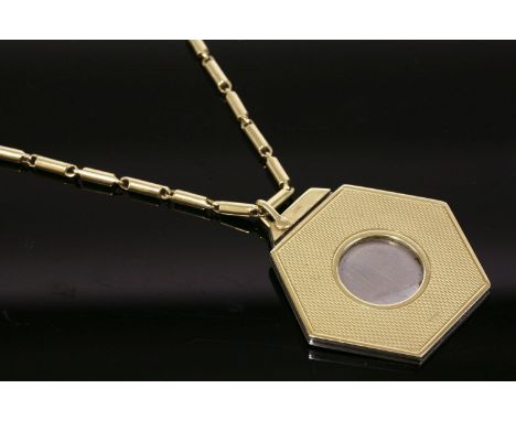 A 9ct gold cigar cutter,of hexagonal form with fine barley engine turned decoration, London 1956, suspended on a 9ct gold tub