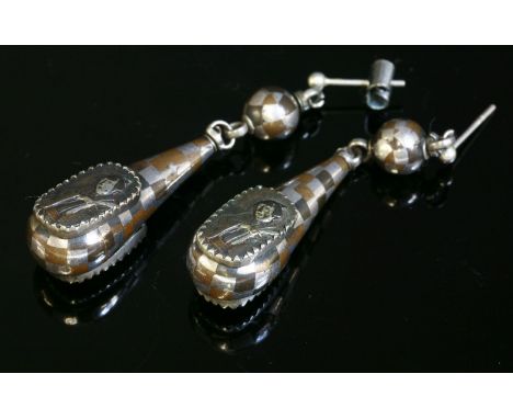 A pair of Victorian mixed metal drop earrings, c.1880,with applied Japanese Shakudo style plaques.  Each mixed metal pippin d