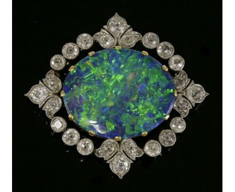 A Belle Époque black opal and diamond brooch, c.1905-1915,with an oval cabochon deep blue/green opal, claw set in a yellow co